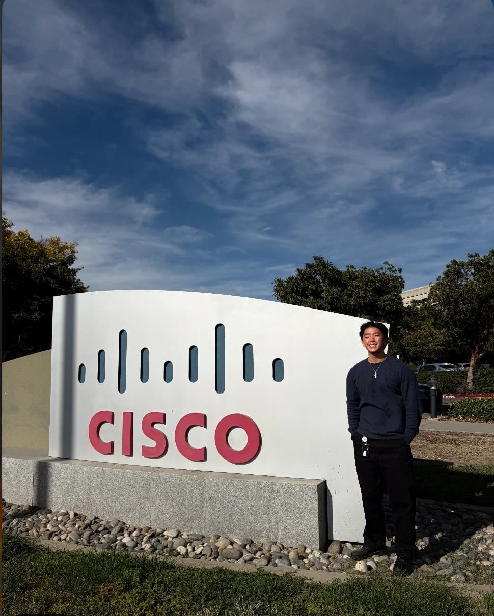 Ryan standing next to the Cisco sign