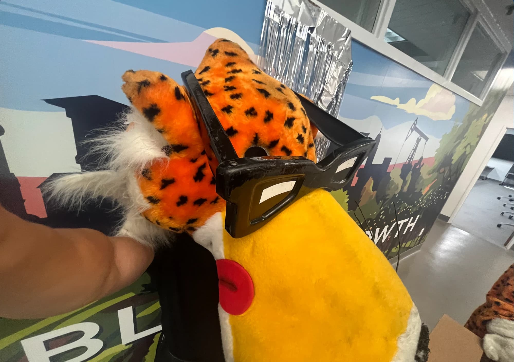 Chester Cheetah mascot head with oversized glasses