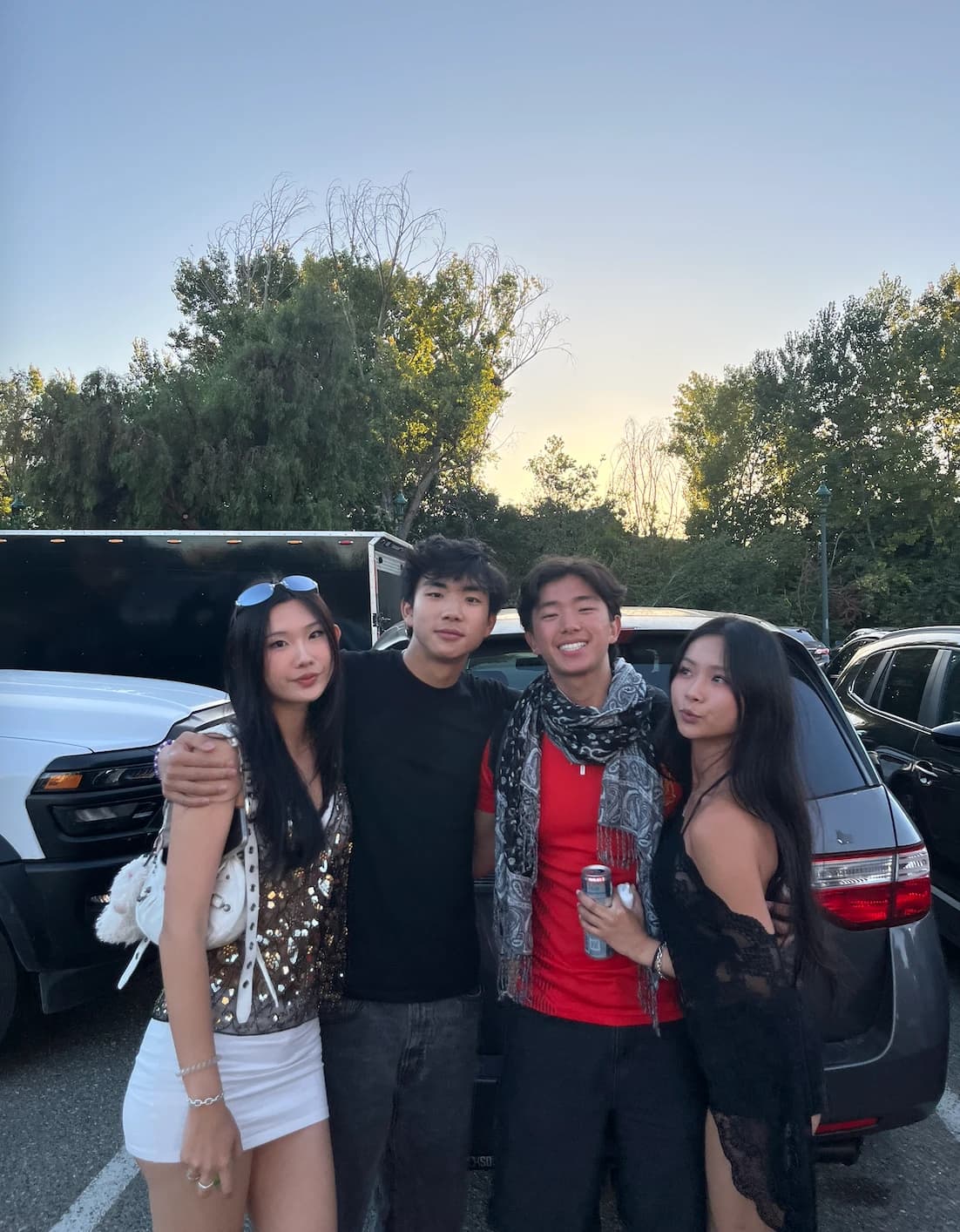 Ryan and friends in a parking lot at dusk