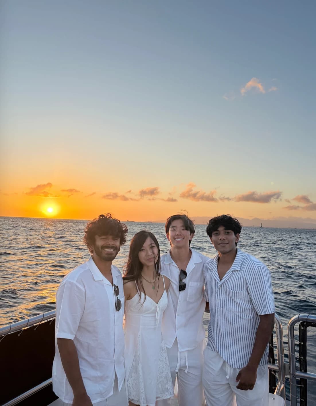 Ryan and friends on a boat at sunset in Hawaii