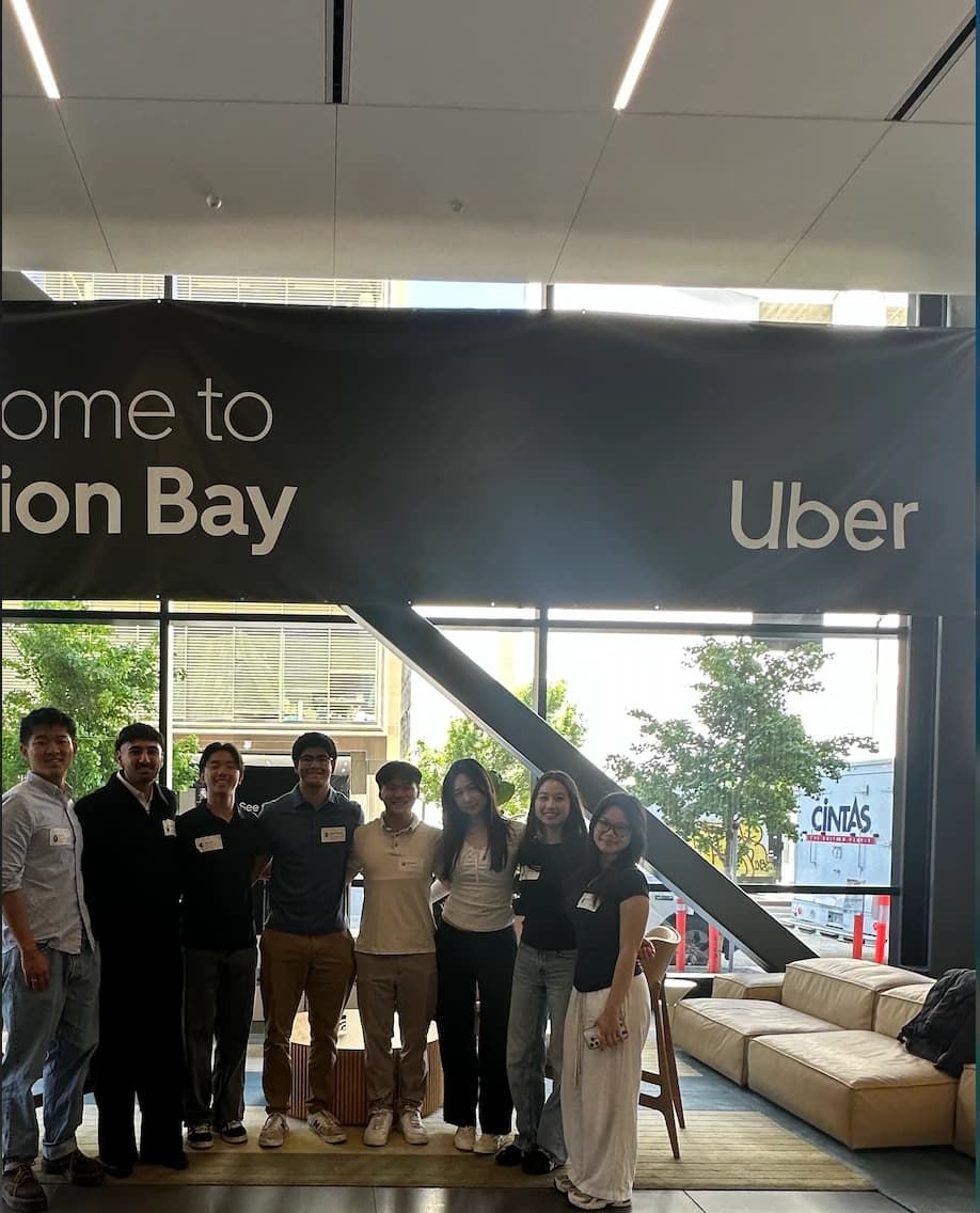 The team standing under an Uber welcome banner